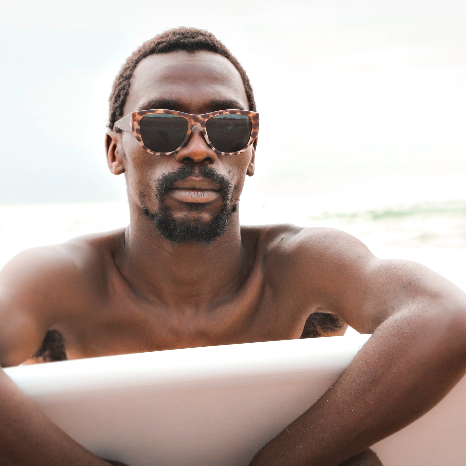 South African professional surfer, Avuyile "Avo" Ndamase, wearing The DiMaggios sunglasses by Ûs the Movement. Photo by Barry Tuck
